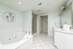 Spacious primary bath with Jacuzzi tub and walk in shower